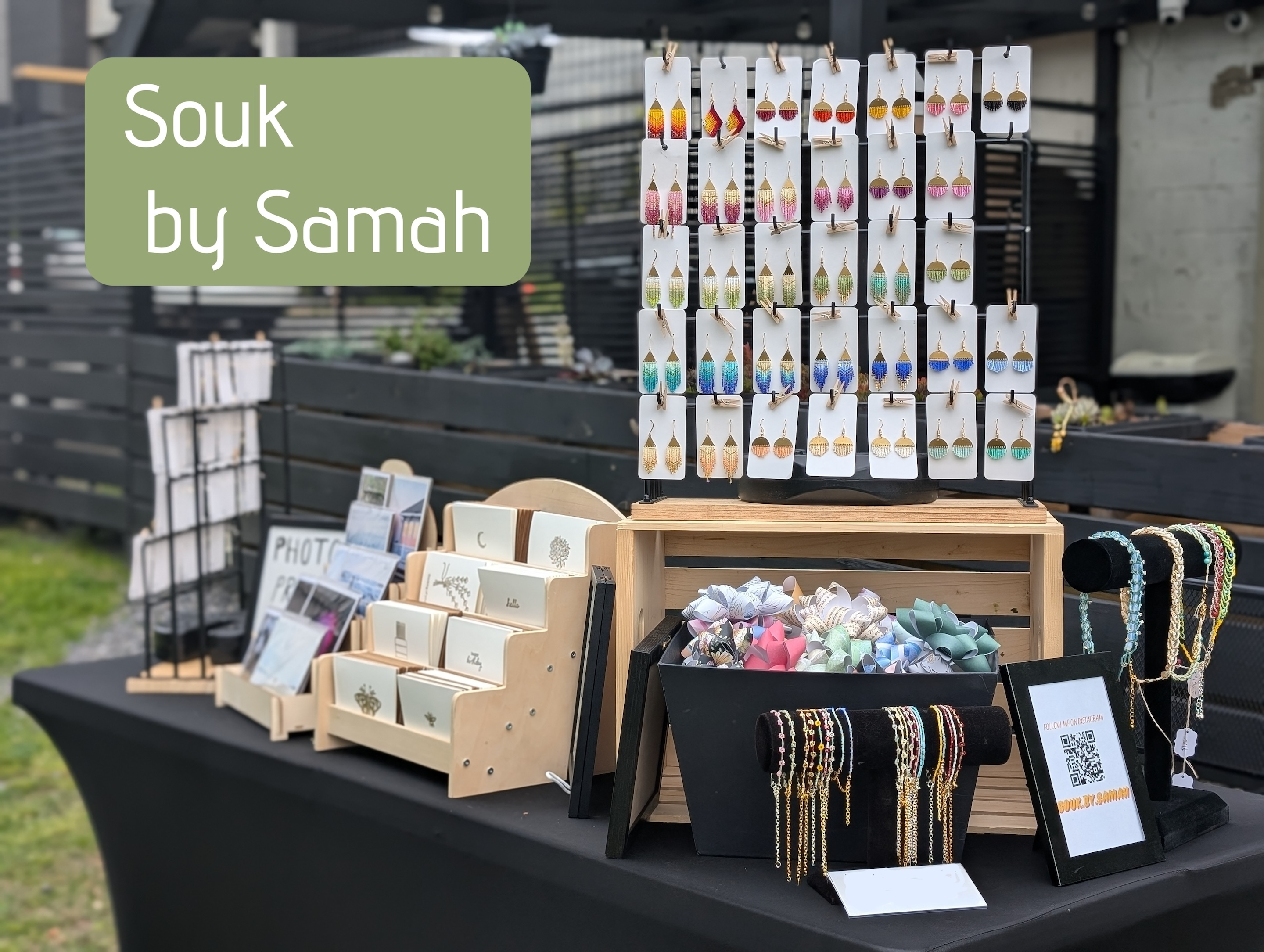 A table displaying many items that Souk By Samah sells - jewelry, gift bows, greeting cards, etc.